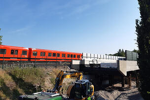 Metrojuna ajaa Kipparlahden metrosiltatyömaan ohi.