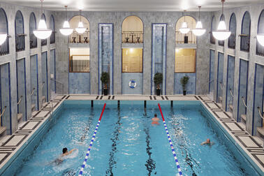 Ihmisiä uimassa Yrjönkadun perusparannetussa uimahallissa ensimmäisen kerroksen altaassa.