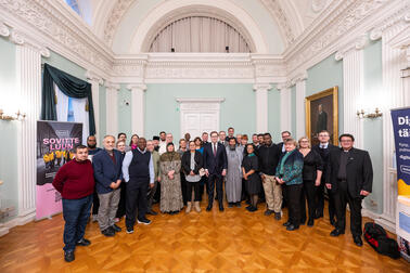 Dozens of people gathered for a group photo in the Empire hall.