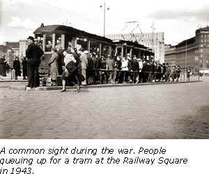 People queuing up for a tram at the Railway Square in 1943.