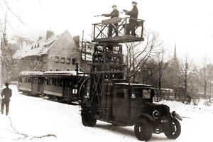 Repairing overhead lines after an air raid.