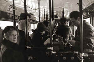 A conductor and passengers in the mid-1970s.